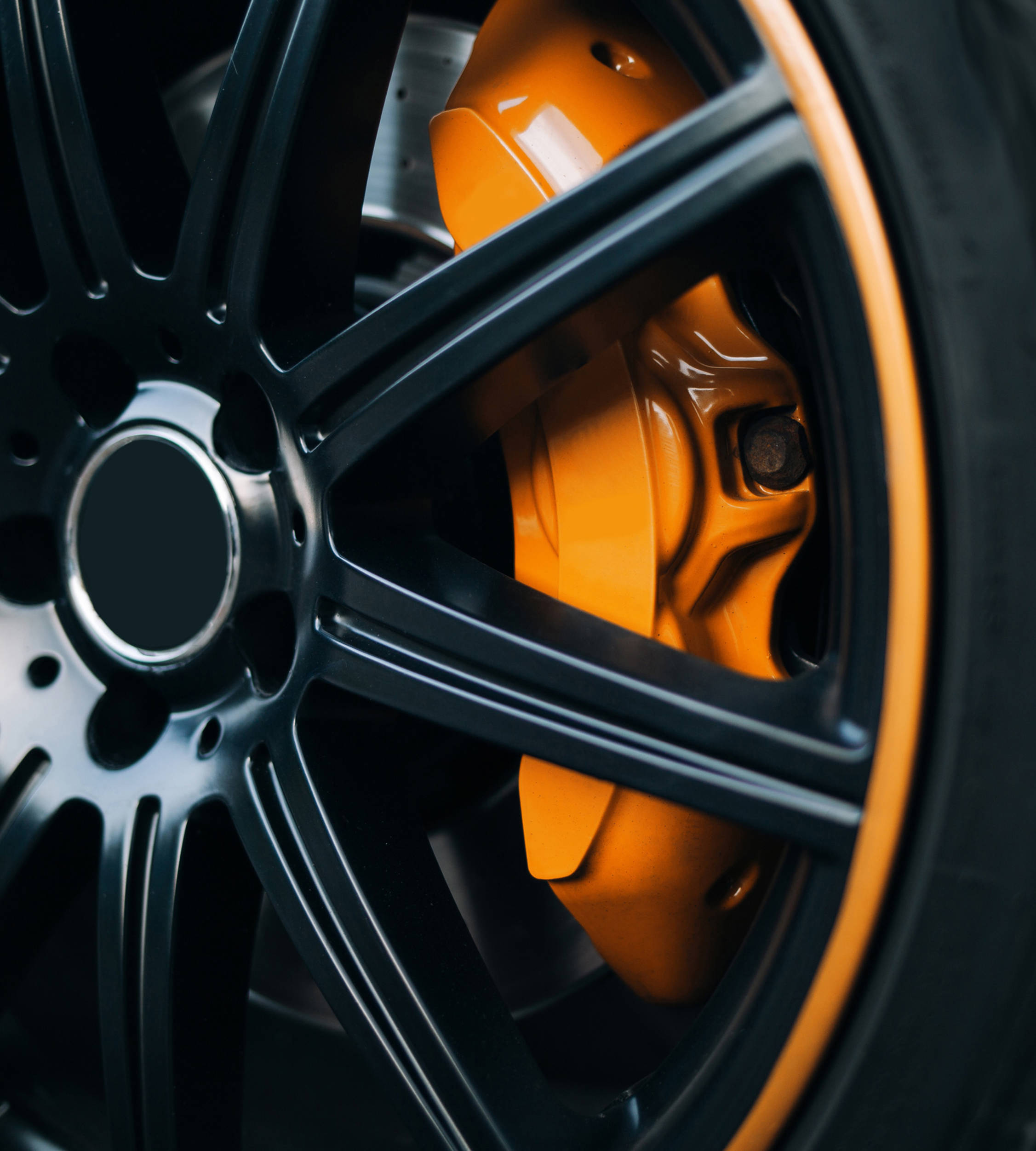 Automotive yellow and black coated wheel close up