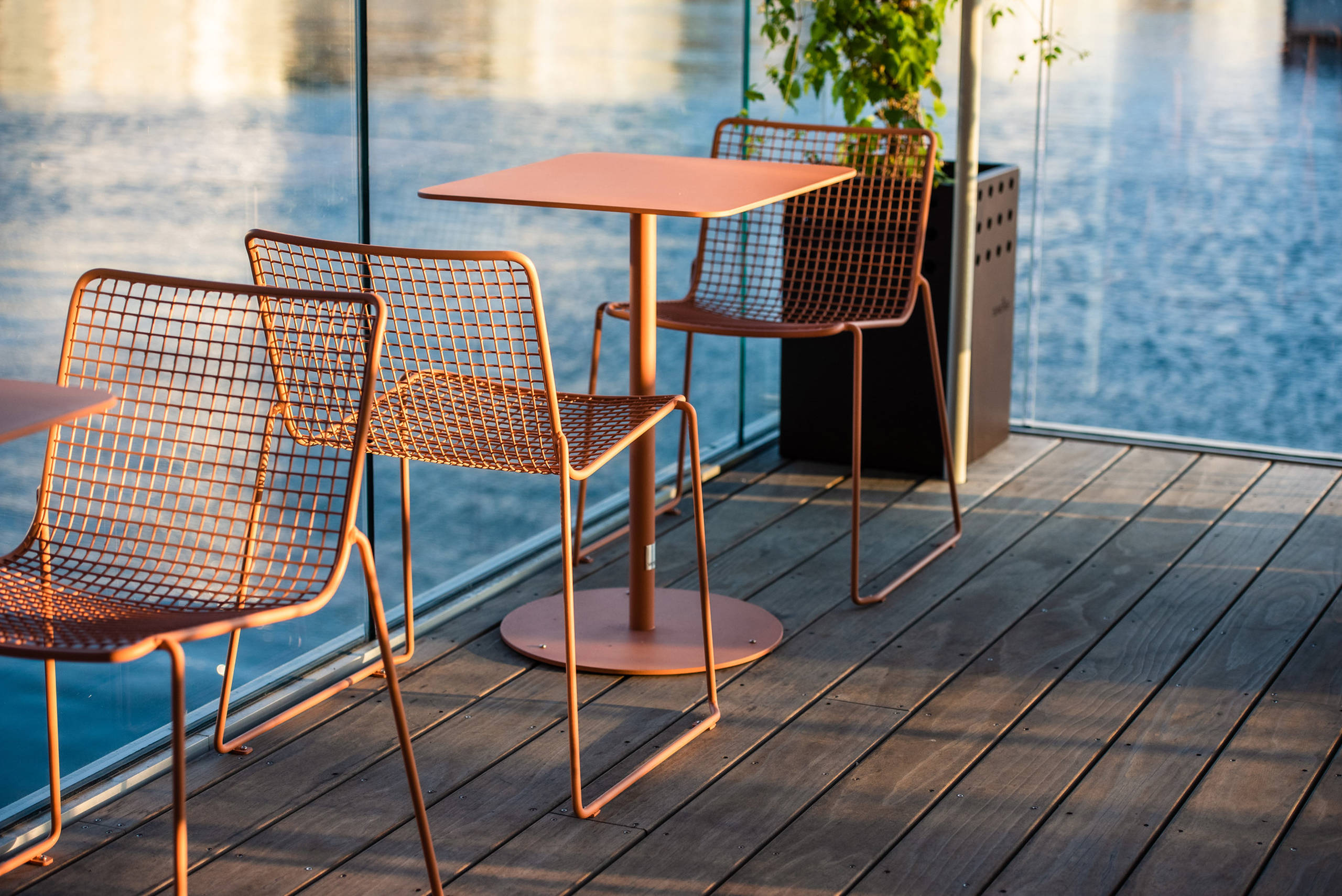 2 steel chairs and table on pool deck