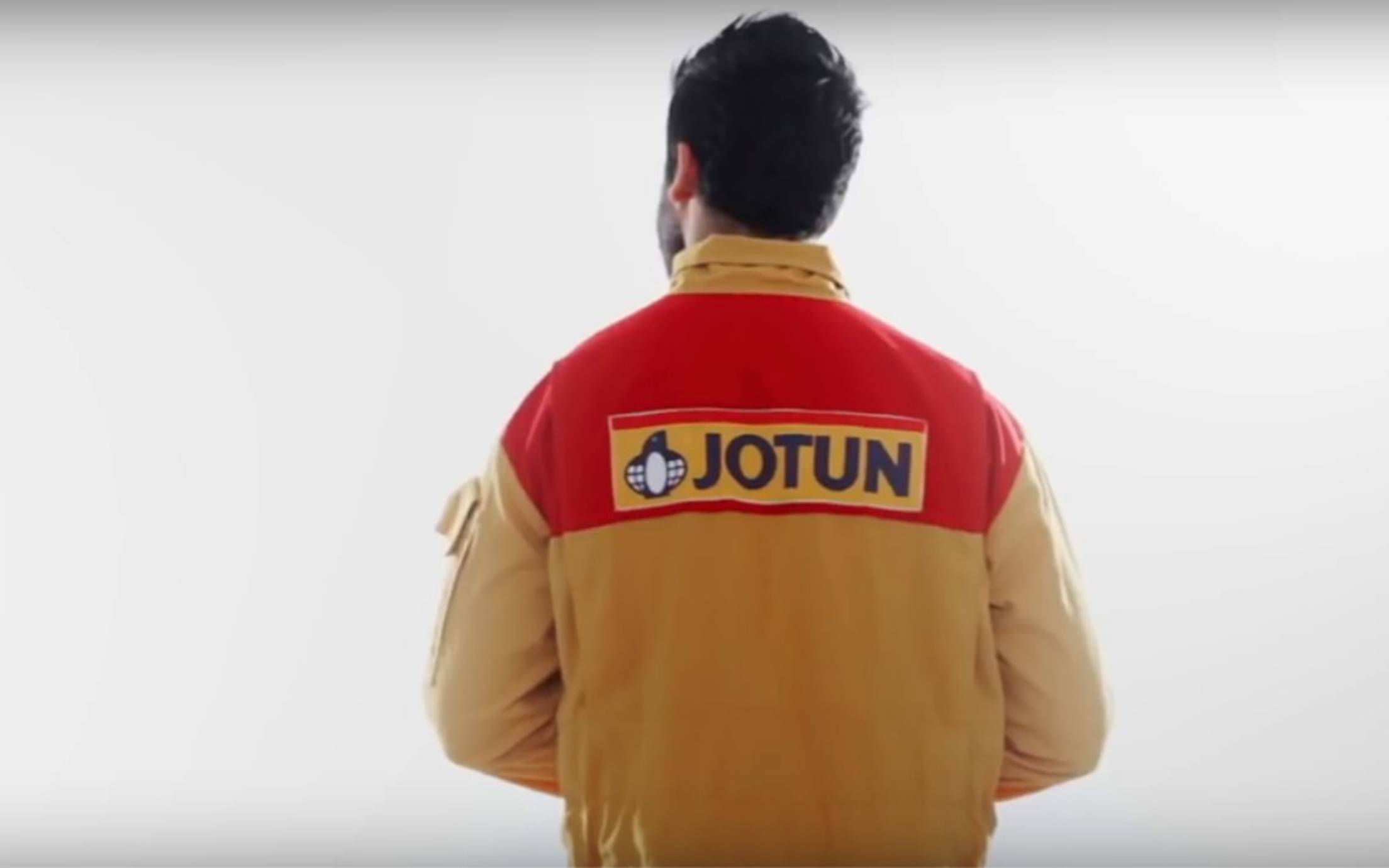 The back of a painter wearing a Jotun uniform