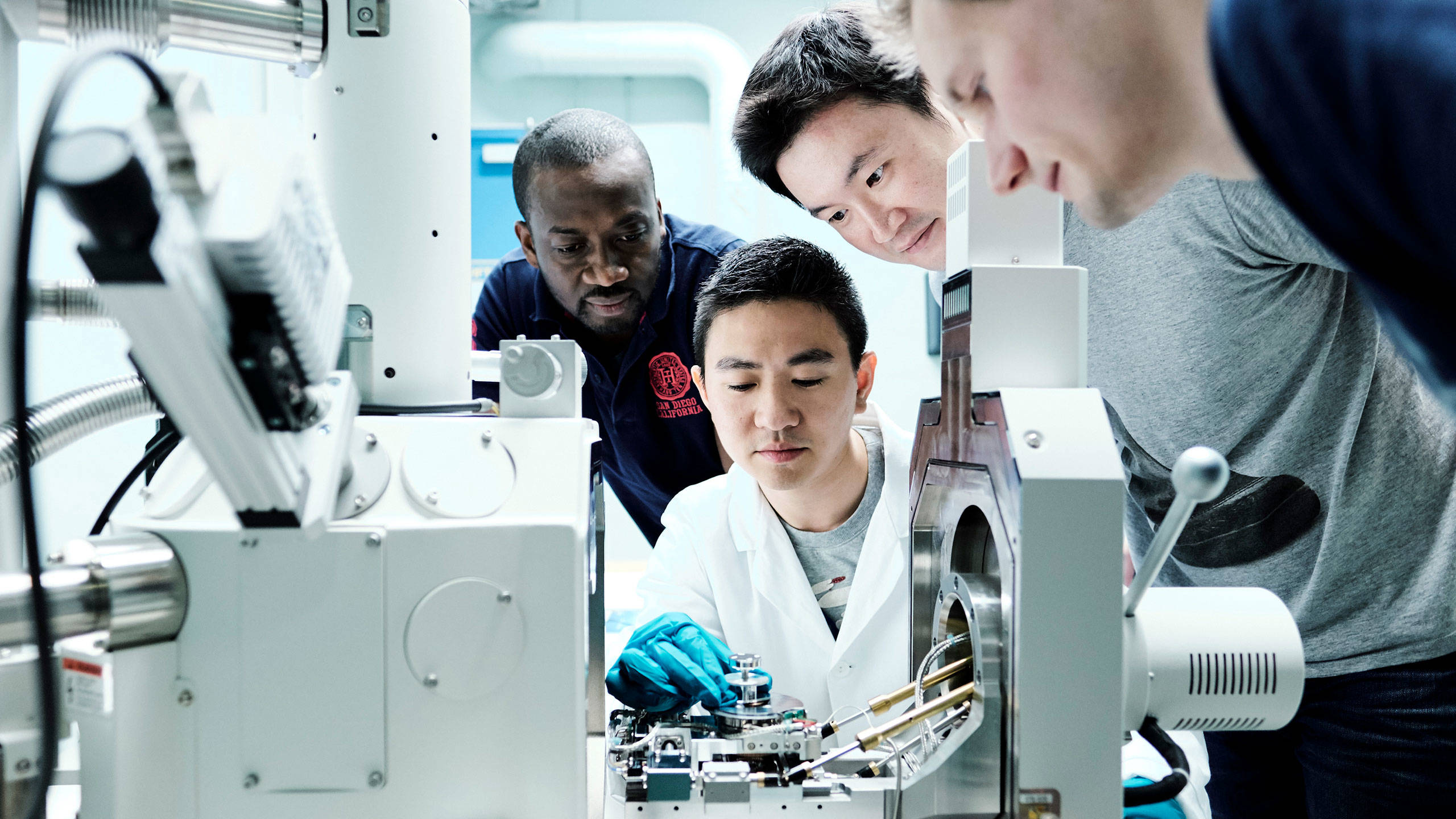 Looking into an advanced microscope at Jotun's Research and Development centre in Sandefjord, Norway